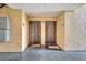 Building entrance featuring two unit doors with welcome mats. It is a covered entryway at 8801 Latrec Ave # 8101, Orlando, FL 32819