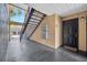 Exterior entrance featuring a black door, staircase, and concrete walkway at 8801 Latrec Ave # 8101, Orlando, FL 32819