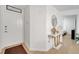 Bright entryway with white walls, a decorative console table, and a wood-look floor at 8801 Latrec Ave # 8101, Orlando, FL 32819