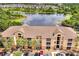 Charming condo building with well-maintained landscaping, palm trees, and convenient parking spaces at 8801 Latrec Ave # 8101, Orlando, FL 32819