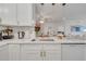 Updated kitchen boasting white quartz countertops, stainless steel sink, and gold hardware at 8801 Latrec Ave # 8101, Orlando, FL 32819