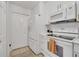All-white kitchen featuring stainless steel appliances, tile flooring, and ample storage at 8801 Latrec Ave # 8101, Orlando, FL 32819