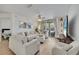 Open concept living room with hardwood floors, comfortable seating, and sliding glass doors at 8801 Latrec Ave # 8101, Orlando, FL 32819