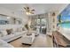 Bright living room featuring hardwood floors, comfortable seating, and sliding glass doors at 8801 Latrec Ave # 8101, Orlando, FL 32819