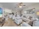 Bright living room with white sofas and a large mirror, seamlessly connecting to the kitchen and dining area at 8801 Latrec Ave # 8101, Orlando, FL 32819