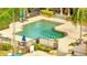 Community swimming pool with lounge chairs and lush landscaping at 8801 Latrec Ave # 8101, Orlando, FL 32819