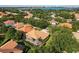 A bird's-eye view shows a beautiful neighborhood with lush greenery and glimpses of a serene lake at 9128 Phillips Grove Ter, Orlando, FL 32836
