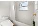 Bathroom showcasing a bathtub and shower combo with all white tiled walls at 9128 Phillips Grove Ter, Orlando, FL 32836