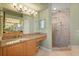 Bathroom featuring a sink with a granite countertop and a shower with brick surround at 9128 Phillips Grove Ter, Orlando, FL 32836