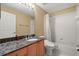 Bathroom featuring granite countertops, sink, toilet and shower with curtain at 9128 Phillips Grove Ter, Orlando, FL 32836