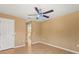 Neutral bedroom featuring wood floors, neutral paint, and ceiling fan with a light at 9128 Phillips Grove Ter, Orlando, FL 32836