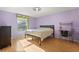 This bedroom features a window providing natural light and light purple paint at 9128 Phillips Grove Ter, Orlando, FL 32836