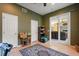 The bonus room features a large area rug, white trim, and neutral paint, with a glimpse into the living room at 9128 Phillips Grove Ter, Orlando, FL 32836