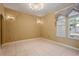 Formal dining room with tile flooring, ornate chandelier, sconce lighting and natural light from the large window at 9128 Phillips Grove Ter, Orlando, FL 32836