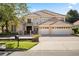Beautiful two-story home featuring a tile roof, balcony, gated entrance, and a three-car garage at 9128 Phillips Grove Ter, Orlando, FL 32836