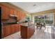 Charming kitchen with wooden cabinets, granite countertops, and natural light at 9128 Phillips Grove Ter, Orlando, FL 32836