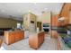 An open kitchen featuring wood cabinetry, granite countertops, tile floors, and stainless steel appliances at 9128 Phillips Grove Ter, Orlando, FL 32836