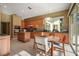 A spacious kitchen featuring tile floors, wooden cabinets, granite countertops, and stainless steel appliances at 9128 Phillips Grove Ter, Orlando, FL 32836