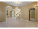 Open-concept living room features tile flooring, arched doorways, pillars, and staircase at 9128 Phillips Grove Ter, Orlando, FL 32836
