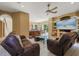 A comfortable living room with tile floors, neutral walls, an archway to the kitchen, and a ceiling fan at 9128 Phillips Grove Ter, Orlando, FL 32836