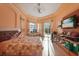 Spacious bedroom with a decorative tray ceiling, a large window, and a sliding door to the backyard at 9128 Phillips Grove Ter, Orlando, FL 32836