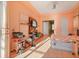 Sunlit bedroom featuring a large window, a decorative ceiling, and a door to the bathroom at 9128 Phillips Grove Ter, Orlando, FL 32836