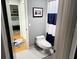 Neat bathroom featuring a toilet and a striped shower curtain with neutral gray colored walls at 954 N Texas Ave, Orlando, FL 32804