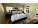 Comfortable bedroom showcasing a king bed, wood floors, and windows with wooden blinds at 954 N Texas Ave, Orlando, FL 32804