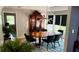 Open dining room with a wooden table, chairs, modern lighting, and a large window at 954 N Texas Ave, Orlando, FL 32804