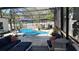 Screened-in pool area with lounge seating, umbrellas, manicured plants, and outdoor living space at 954 N Texas Ave, Orlando, FL 32804