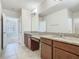 Well-appointed bathroom featuring double vanities, granite countertops, and ample mirror space at 9971 Beach Port Dr, Winter Garden, FL 34787