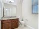 This bathroom features granite counters, tile floors, and brown cabinets at 9971 Beach Port Dr, Winter Garden, FL 34787