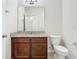 A clean, modern bathroom with granite counters, brown cabinets and tile flooring at 9971 Beach Port Dr, Winter Garden, FL 34787