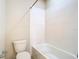 Bathroom with white tiled walls and a toilet at 9971 Beach Port Dr, Winter Garden, FL 34787