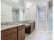 Elegant bathroom featuring double vanities, granite countertops, and stylish fixtures at 9971 Beach Port Dr, Winter Garden, FL 34787