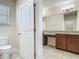 Stylish bathroom features double sink vanity with granite countertops and a separate toilet room at 9971 Beach Port Dr, Winter Garden, FL 34787