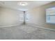 Bright, carpeted bedroom featuring neutral walls and abundant natural light from three windows at 9971 Beach Port Dr, Winter Garden, FL 34787