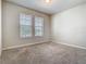 Carpeted bedroom featuring neutral paint, plush carpet, and two windows at 9971 Beach Port Dr, Winter Garden, FL 34787