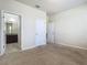 Neutral bedroom with beige carpet and doors to the bathroom and hallway at 9971 Beach Port Dr, Winter Garden, FL 34787