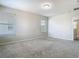 Carpeted bedroom with multiple windows, neutral walls, and access to an adjacent room at 9971 Beach Port Dr, Winter Garden, FL 34787