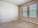 Carpeted bedroom with two windows for ample natural light at 9971 Beach Port Dr, Winter Garden, FL 34787