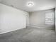 Spacious bonus room featuring neutral paint, plush carpet, and natural light from a window at 9971 Beach Port Dr, Winter Garden, FL 34787