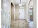 Inviting foyer with tile flooring, showcasing a staircase and an open entryway leading to the home's interior at 9971 Beach Port Dr, Winter Garden, FL 34787