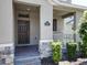 Close-up of the front entrance with a well-maintained garden and a brick walkway at 9971 Beach Port Dr, Winter Garden, FL 34787