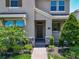 Inviting front entrance with manicured landscaping and stone accents at 9971 Beach Port Dr, Winter Garden, FL 34787