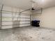Spacious garage with concrete flooring and a large door at 9971 Beach Port Dr, Winter Garden, FL 34787
