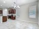A well lit kitchen with granite countertops, stainless steel appliances, and tile flooring at 9971 Beach Port Dr, Winter Garden, FL 34787