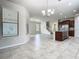Open concept kitchen with brown cabinets, granite counters, tile flooring, and stainless steel appliances at 9971 Beach Port Dr, Winter Garden, FL 34787