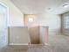 Open loft area featuring neutral paint, plush carpet, and natural light from a window at the top of the stairs at 9971 Beach Port Dr, Winter Garden, FL 34787
