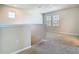 Open loft area featuring neutral paint, plush carpet, and two windows at 9971 Beach Port Dr, Winter Garden, FL 34787